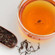 Load image into Gallery viewer, Hwa Gung Tea HGT Legends Series Hakka Oriental Beauty Oolong Tea tea soup and strip shaped loose tea leaves