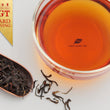 Load image into Gallery viewer, Hwa Gung Tea award winning Eternity Series Reserved LiShan Alpine Oolong Black Tea tea soup and strip shaped loose tea leaves