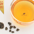 Load image into Gallery viewer, Hwa Gung Tea's award winning Eternity Series Reserved LiShan Alpine Red Oolong Tea tea soup and ball shaped loose tea leaves