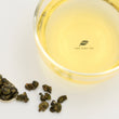 Load image into Gallery viewer, Hwa Gung Tea HGT Legends Series AliShan Alpine Jin-Xuan Tea tea soup and ball shaped loose tea leaves