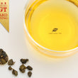 Load image into Gallery viewer, Hwa Gung Tea Legends Series Chuan-Fang Classic Estate Oolong Tea tea soup and ball shaped loose tea leaves