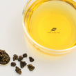 Load image into Gallery viewer, Hwa Gung Tea Legends Series Selected Dong Ding Oolong Tea tea soup and ball shaped loose tea leaves