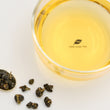 Load image into Gallery viewer, Hwa Gung Tea Legends Series Shy-Jih-Chuen Oolong Tea tea soup and ball shaped loose tea leaves