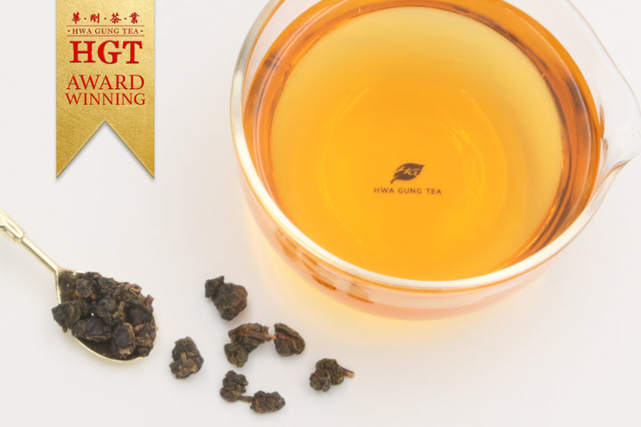 Hwa Gung Tea's award winning Eternity Series Reserved LiShan Alpine Red Oolong Tea tea soup and ball shaped loose tea leaves