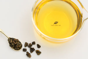 Hwa Gung Tea Legends Series Selected Dong Ding Oolong Tea tea soup and ball shaped loose tea leaves